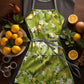 Lemon On Green Apron by Mark van Vuuren